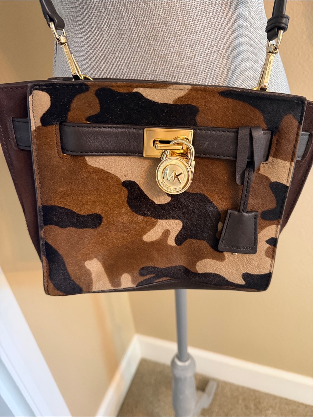 A Michael Kors camouflage calf hair satchel featuring gold tone hardware